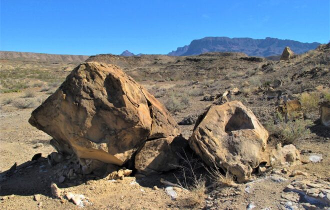 Boulders in the desert with the mountains in the background in Big Bend National Park