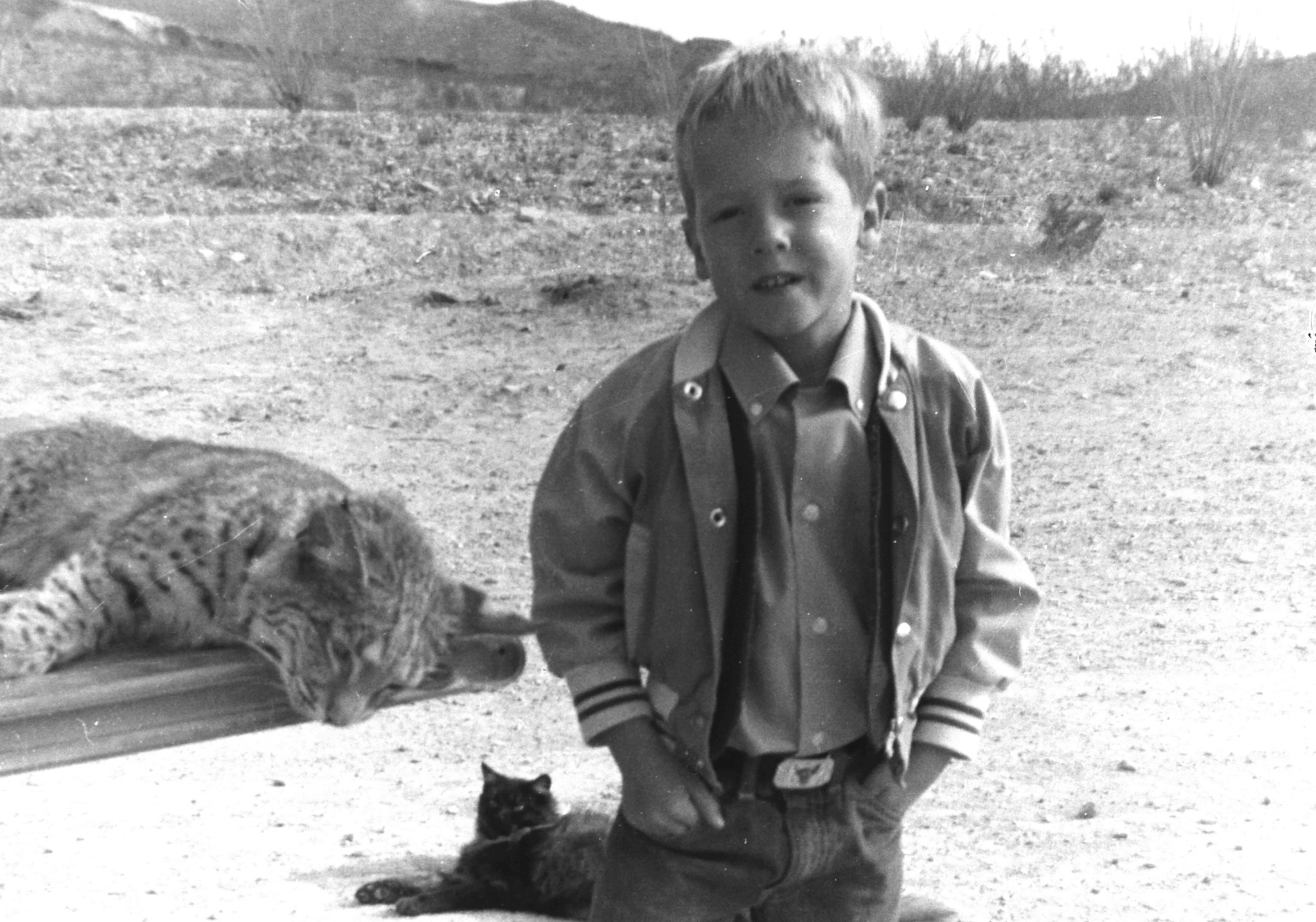 Young Barry in the Big Bend Black and white photo of a young boy looking directly at the camera, with desert scenery behind him.